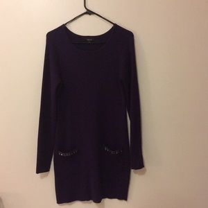 Dark purple sweater dress with jeweled pockets.